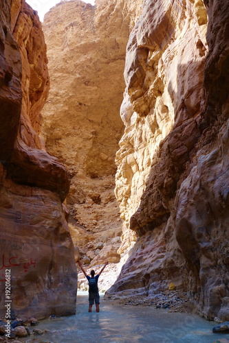 Young adventurous man in Wadi Zarqa Ma'in canyon located in the mountainous landscape to the east of the Dead Sea, near to Wadi Mujib, Jordan, Middle East photo