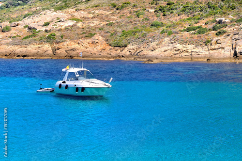 boat on a beautiful blue sea near the coast in Corsica © coco