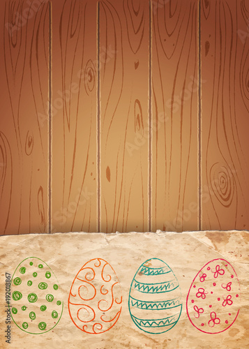 Easter eggs on old paper and wooden background