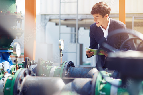 Professional trainee ckecking pressure gauge photo