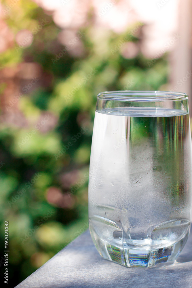 one water glass with blur green background one water glass with blur green background
