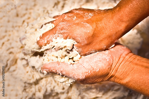 Close up of a human hand making the dough of tan doori roti with maida flour or Cake flour. photo