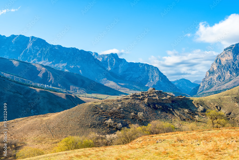 scenery of spring day landscape of Caucasus mountains and Egikal ancient towers in Republic Ingushetia, Russia