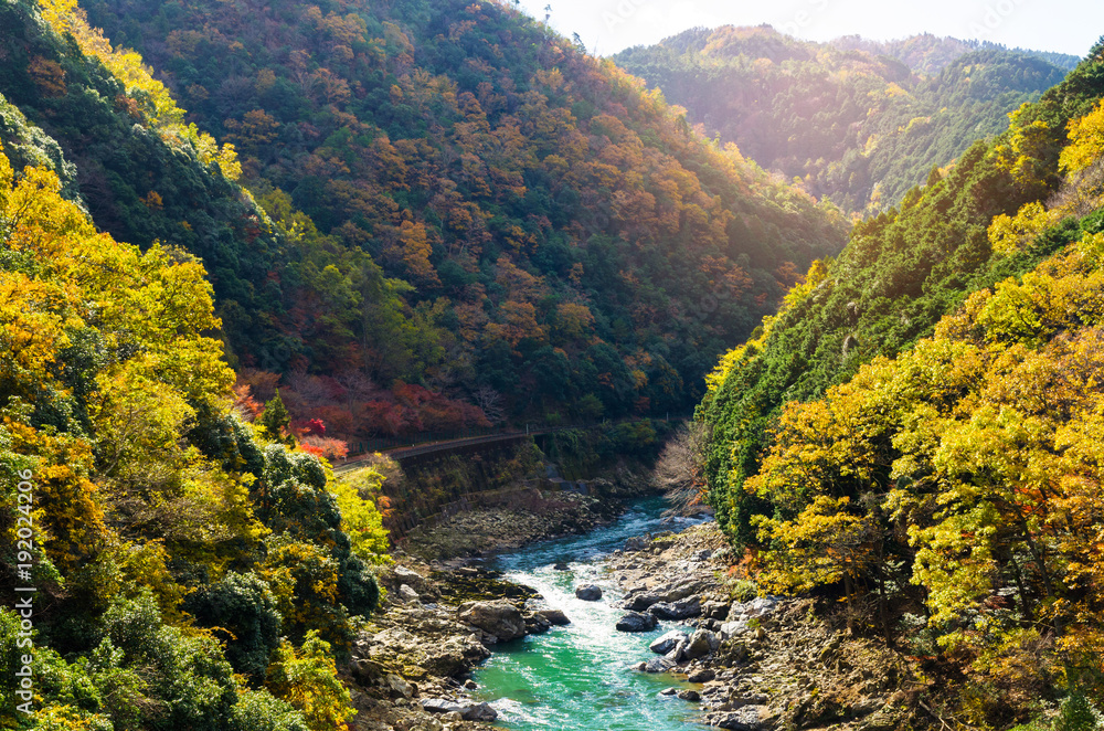 beautiful mountain view in autumn color season with railway and river in Arashiyama, Kyoyo, Hozukyo Station, Japan, soft focus beautiful mountain view in autumn color season with railway and river in Arashiyama, Kyoyo, Hozukyo Station, Japan, soft focus