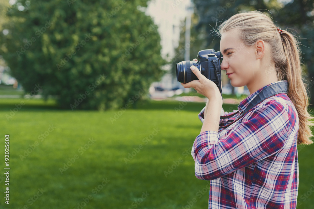 Young woman taking pictures outdoors Young woman taking pictures outdoors
