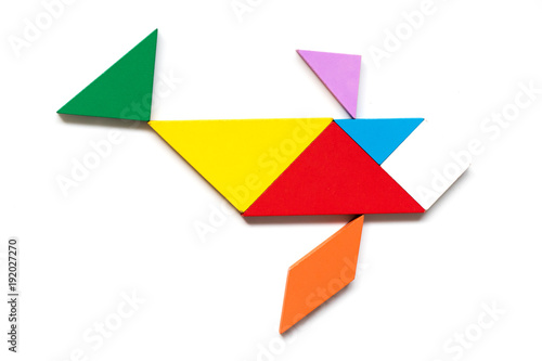 Color wood tangram puzzle in swimming fish shape on white background