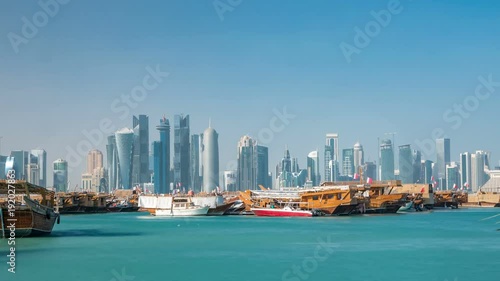 A panoramic view of the old dhow harbour timelapse in Doha, Qatar, with the West Bay skyline in the background. photo