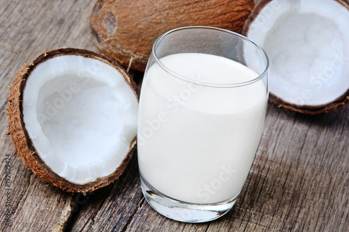 Coconut milk in a glass on rustic table