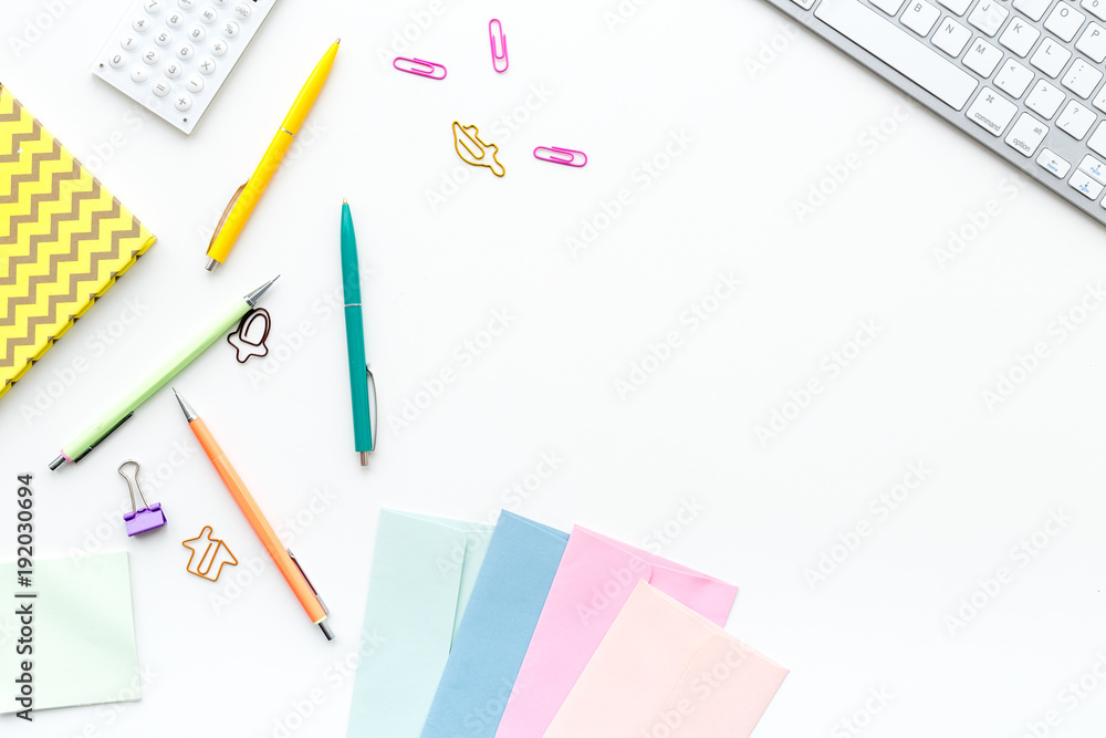 Creative mess on student's desk. Keyboard, notebook, stationery, on white background top view copy space Creative mess on student's desk. Keyboard, notebook, stationery, on white background top view copy space