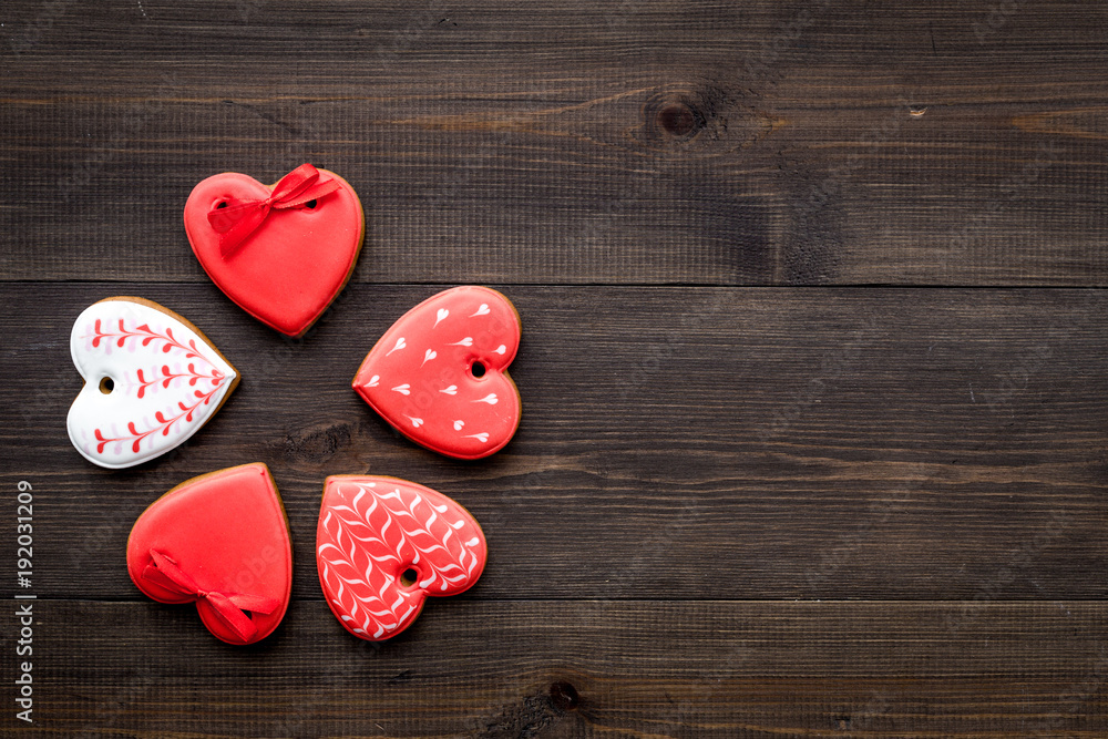 Fototapeta premium St Valentine's Day cookies in shape of heart on dark wooden background top view copy space