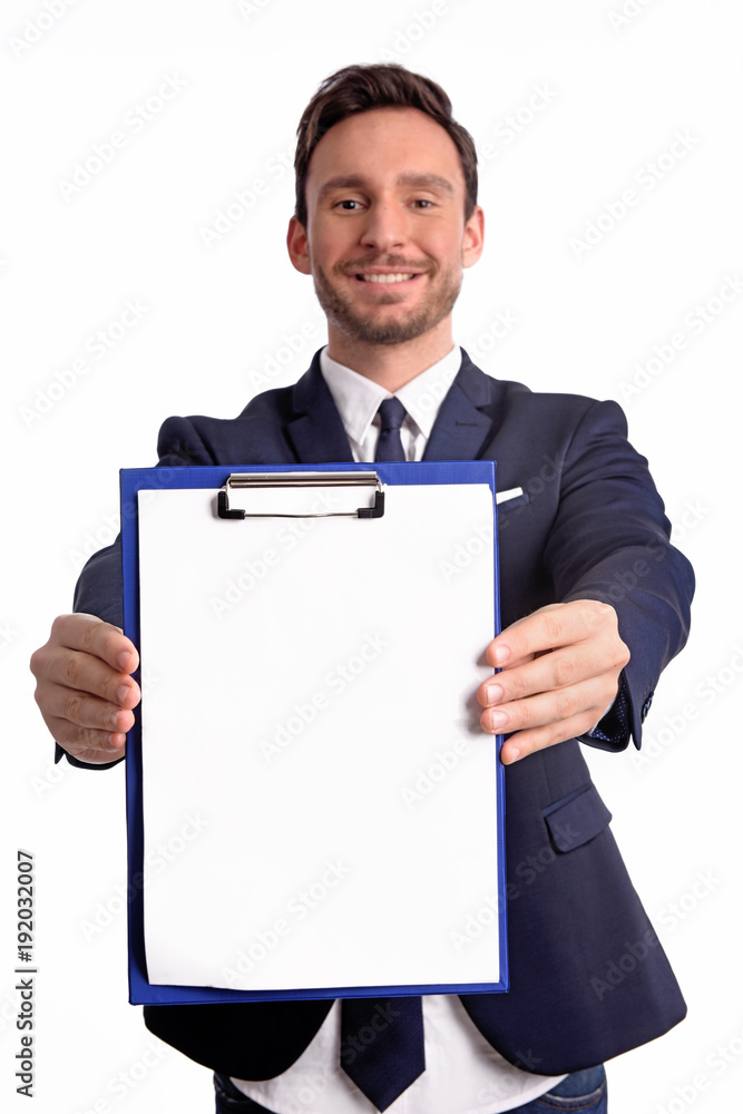 Handsome bearded businessman in office suit and tie isolated on white background. Professional bank manager is holding a blank clipboard Handsome bearded businessman in office suit and tie isolated on white background. Professional bank manager is holding a blank clipboard