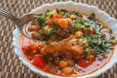 Moroccan soup harira with meat chickpeas lentil tomato lemon and spices in bowl. Arabic food.
 photo