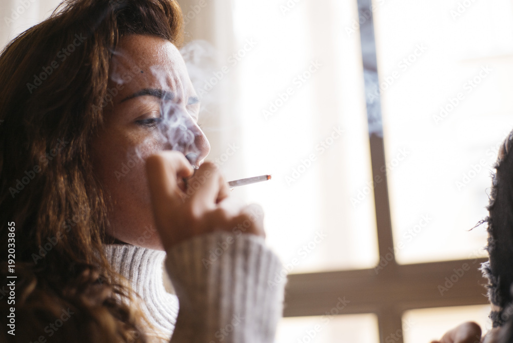 Woman relaxing and smoking Woman relaxing and smoking
