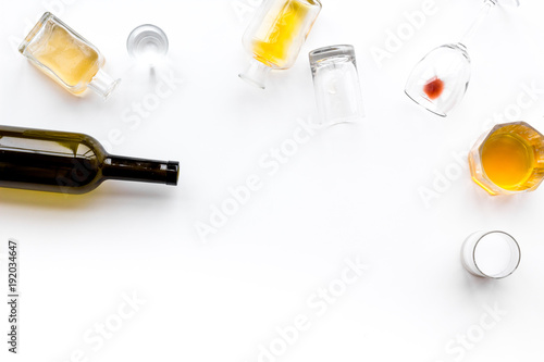 Alcohol abuse. Drunkennes. Glasses and bottles on white background top view copy space photo