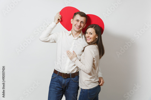 Couple in love. Man and woman with big red heart isolated on white background. Copy space for advertisement. With place for text. St. Valentine's Day International Women's Day birthday holiday concept © ViDi Studio