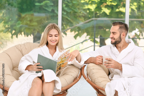Young couple in bathrobes r...