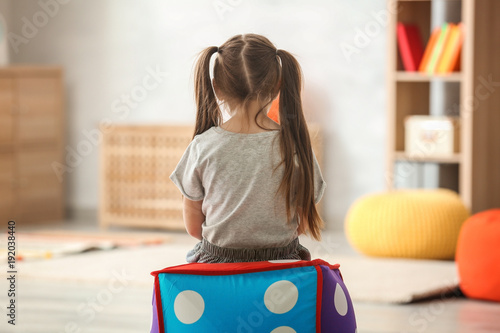 Fotografie Lonely little girl at home. Autism concept