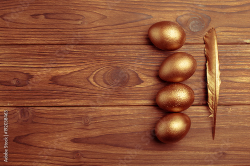 gold eggs on wooden table