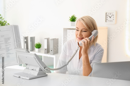 Female receptionist working...
