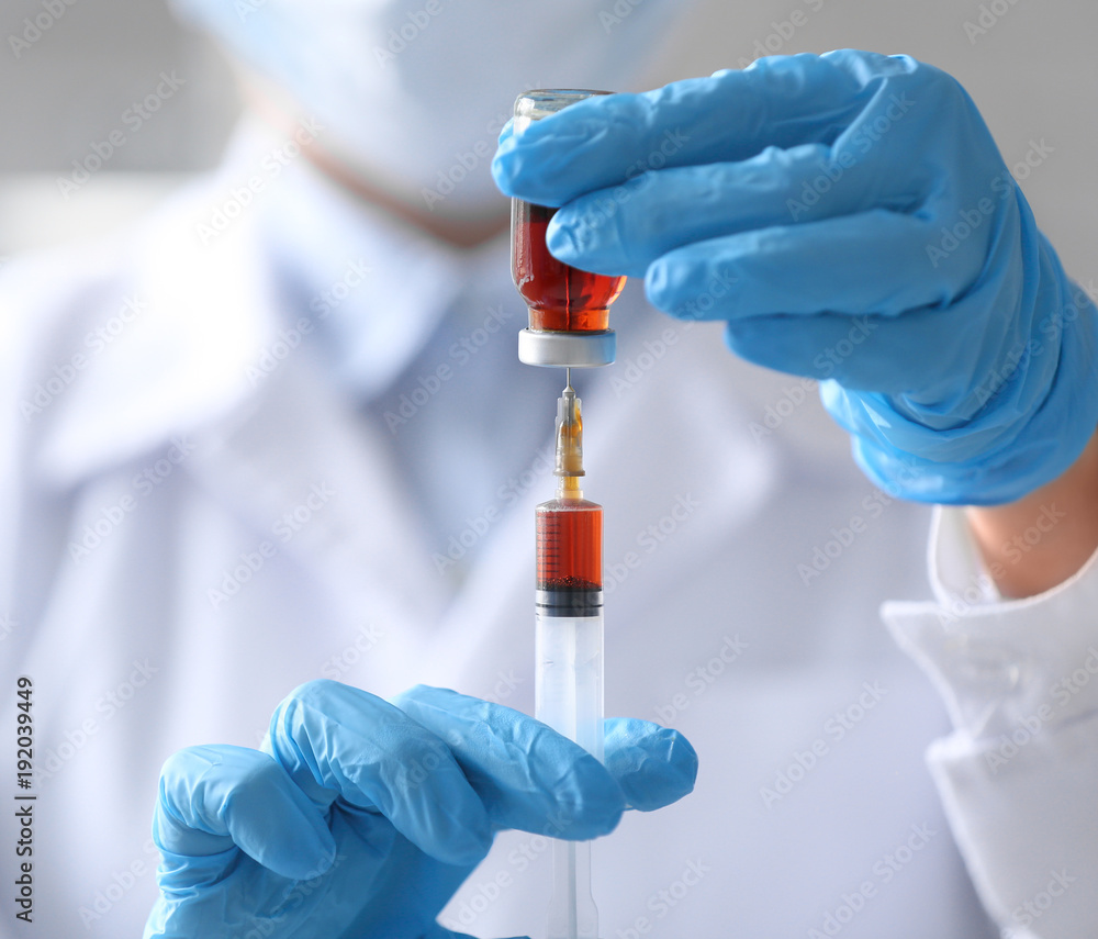 Doctor holding syringe and medicine for vaccination, closeup Doctor holding syringe and medicine for vaccination, closeup