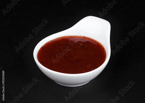 Cranberry sauce in white bowl isolated on black background