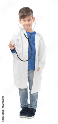 Cute little boy in doctor uniform and with stethoscope on white background