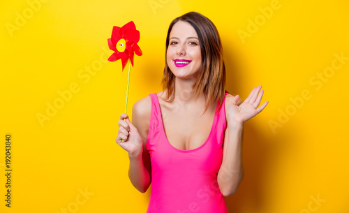 girl in swimming suit holding red pinwheel toy