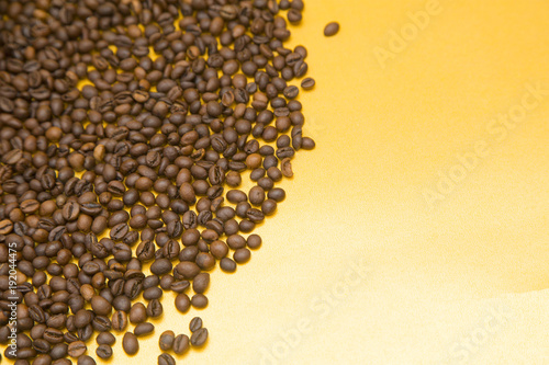 Coffee beans on yellow background. Copyspace and closeup