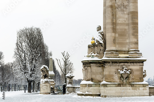 Winter in Paris in the snow. View of the base of the pylon located on the Pont Alexandre III on the right bank of the Seine, upstream side. photo