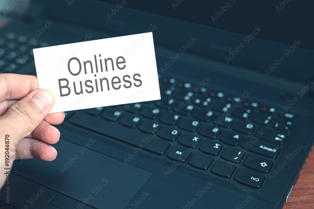Hand showing Online Business text on business card. Hand showing Online Business text on business card.