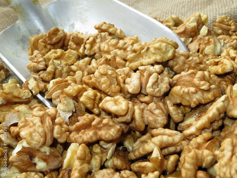 Walnut. Scoop with peeled walnuts on burlap Walnut. Scoop with peeled walnuts on burlap