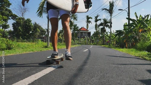 Man gonna surf spot on motorcycle with surfboard. Surfing lifestyle