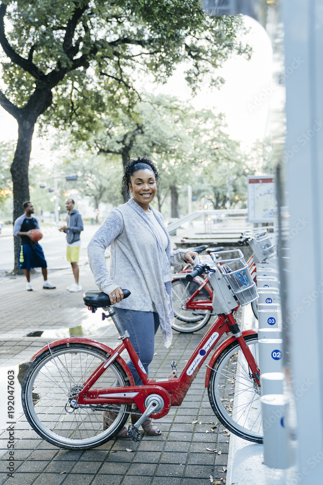 Black woman posing with rental bicycle Black woman posing with rental bicycle