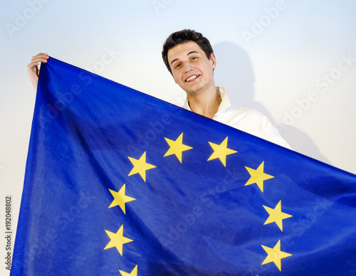 Happy brunette guy with a European flag