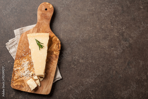 Parmesan cheese on wooden cutting board