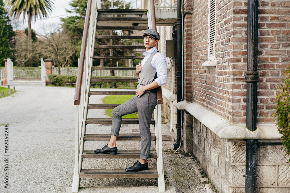 Cheerful man in cap on stairs Cheerful man in cap on stairs