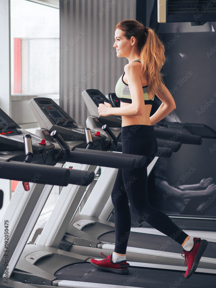 Young girl makes exercises at the gym Young girl makes exercises at the gym