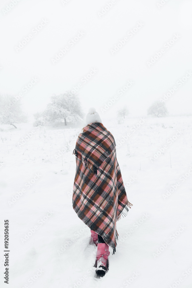 a girl in a plaid in a cage in winter a girl in a plaid in a cage in winter