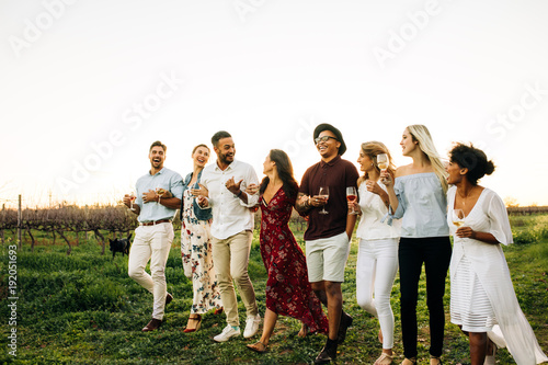 Group of friends chilling outside at vineyard