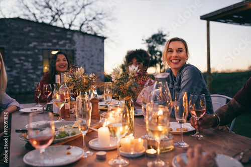 Valokuvatapetti Millennials enjoying dinner in outdoor restaurant