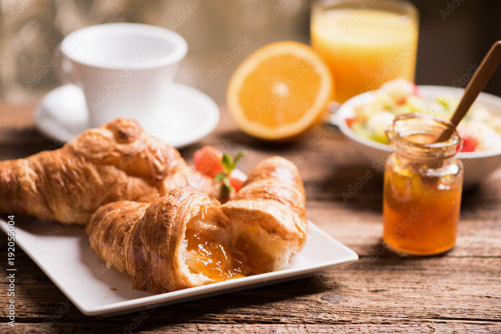 Fresh tasty croissants with berries on blue wooden background Fresh tasty croissants with berries on blue wooden background