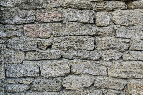 Texture of dark wall is made of natural material. Stone background.