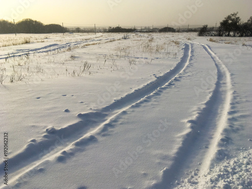 traces of the car on a snowy field