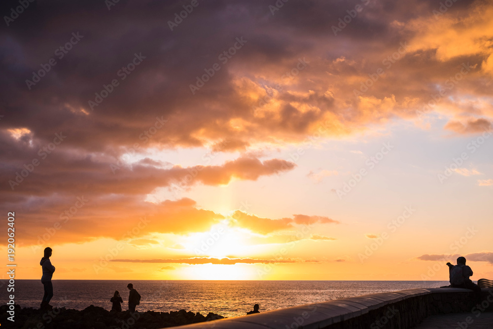 people in silhouette during the golden hour at the sunset in tenerife