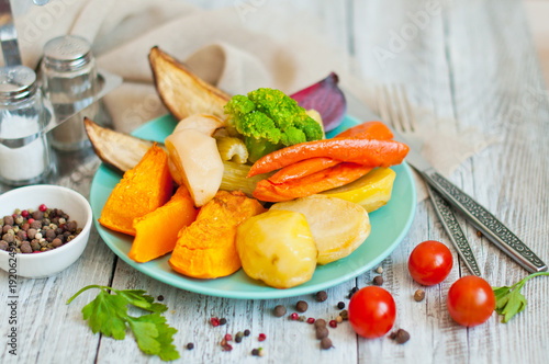 Preparing roasted vegetables with garlic and herbs on rural style . Autumn-winter root vegetables.