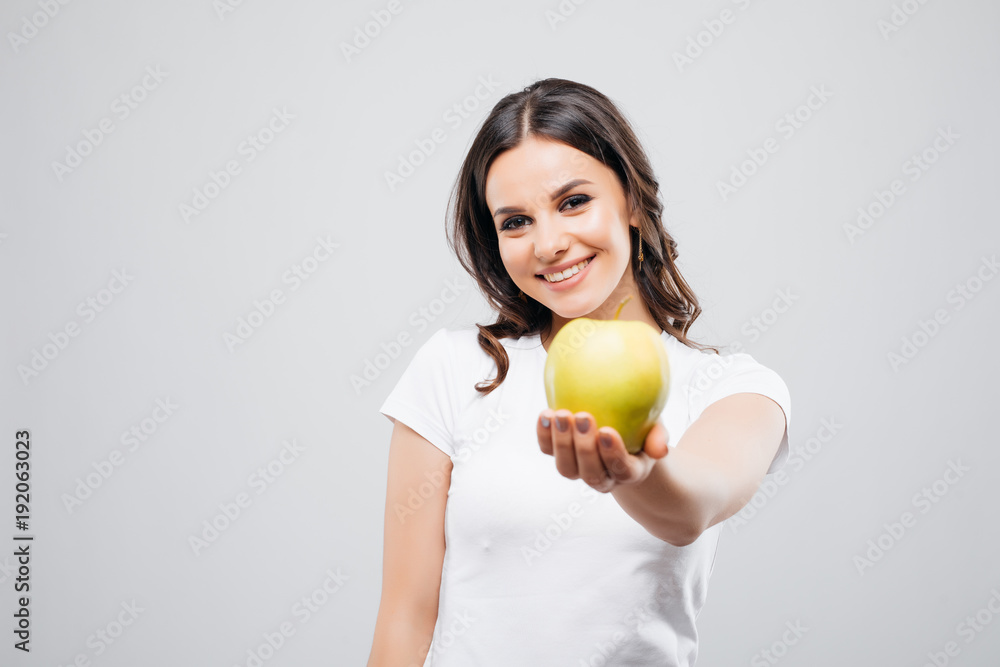 Young happy smiling woman with apple, isolated on white background Young happy smiling woman with apple, isolated on white background