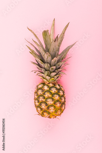 Ripe whole pineapple isolated on pink