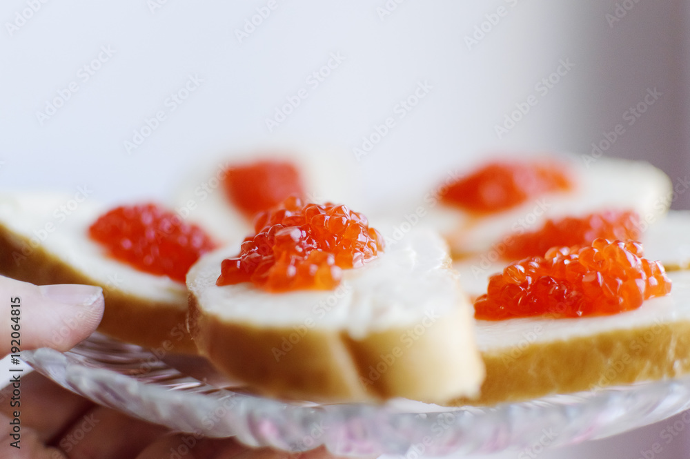 Sandwiches with red caviar lie. Closeup, selective focus. Sandwiches with red caviar lie. Closeup, selective focus.