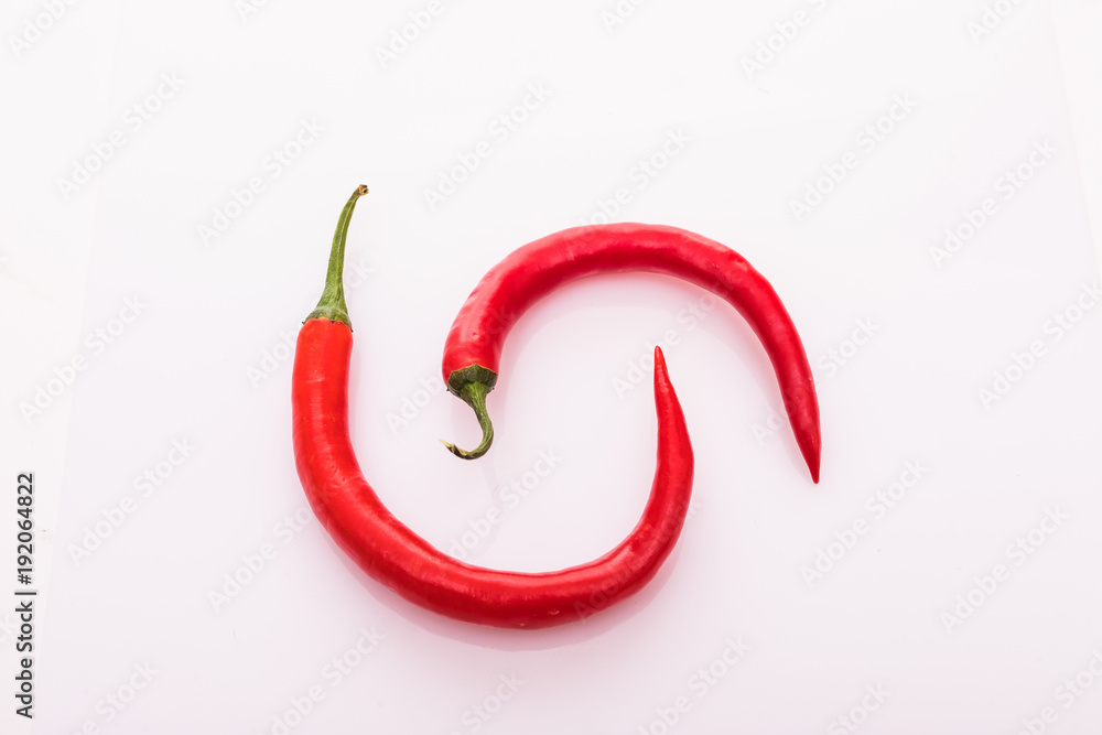 Red peppers isolated on pink background Red peppers isolated on pink background