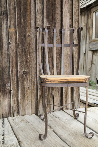 Rusty chair on an old wooden porch